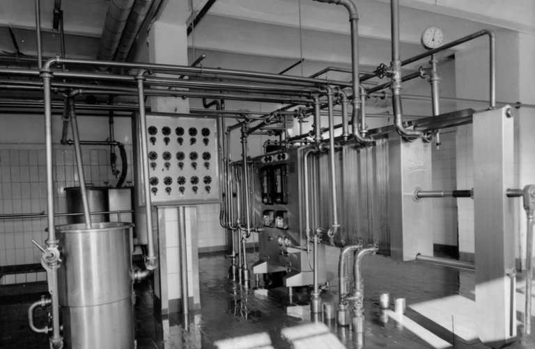 Old dairy plant with pipes and measuring devices. 